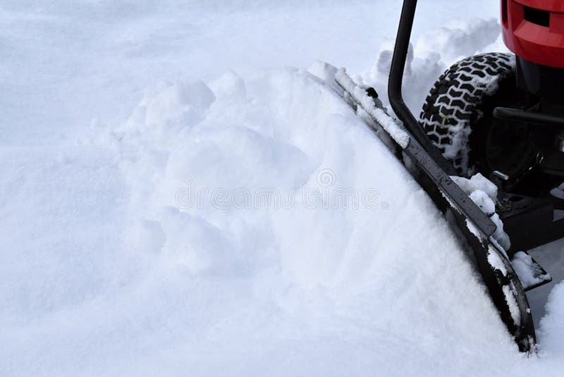 Clearing snow plow garden tractor. Snow. Winter season. Plow. Snow stock photos