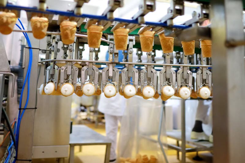 Close-up shot of moving conveyer with ice-cream cones ready for packing stock photos