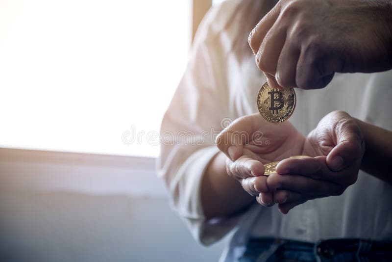 People giving and collecting bitcoins. Closeup image of people giving and collecting bitcoins stock photography