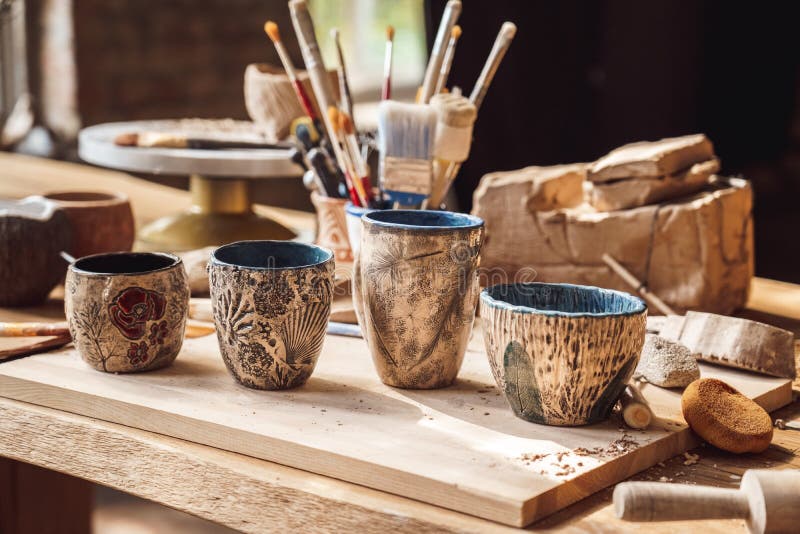 Craftsperson Workspace. Table with materials and tools for pottery isolated creative studio handmade cups with beautiful royalty free stock photography