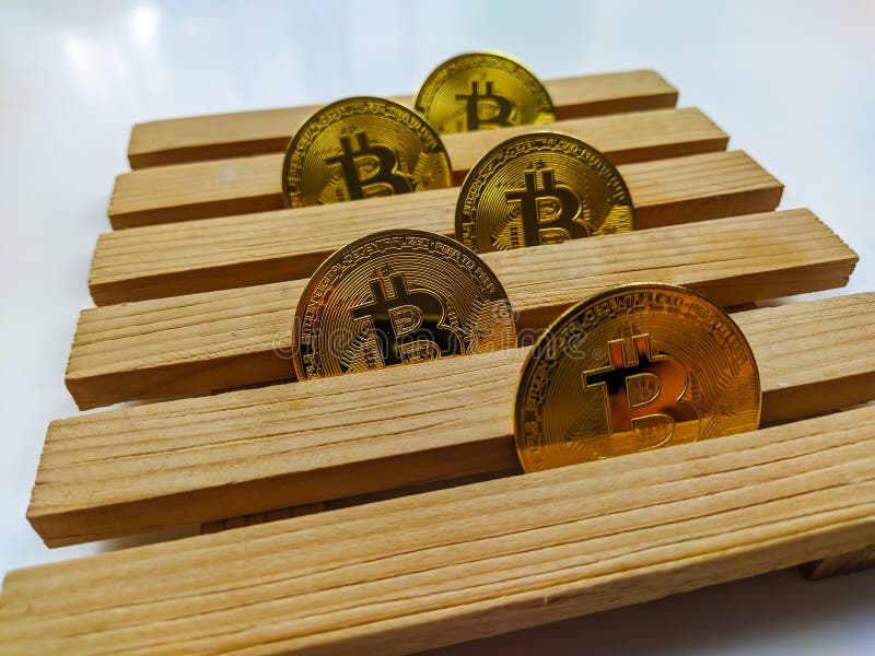 Golden bitcoins lined on wooden platform as a concept of investing and collecting cryptocurrencies based on blockchain technology. Wallpaper stock photography