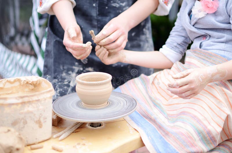 Hands working on throwing wheel, master class of studio pottery. Hands working on throwing wheel,master class of studio pottery stock images