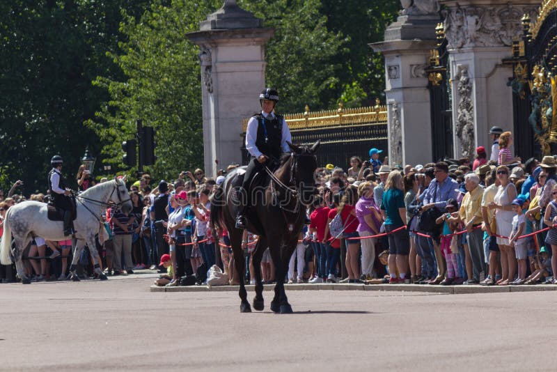 LONDON, UK : JULY, 2015 - The police clearing the area in front of the Buckingham Palace before the Changing of guards. The police clearing the area in front of royalty free stock image