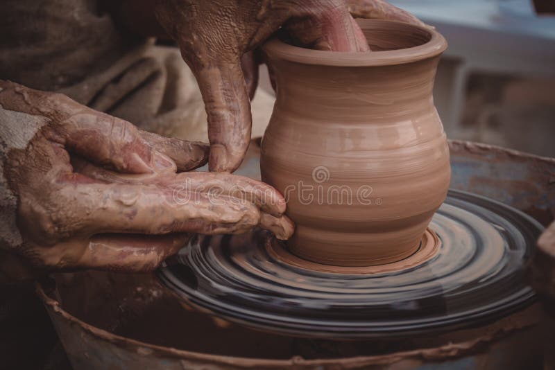 Master class on modeling of clay on a potter`s wheel. In the pottery workshop stock photography