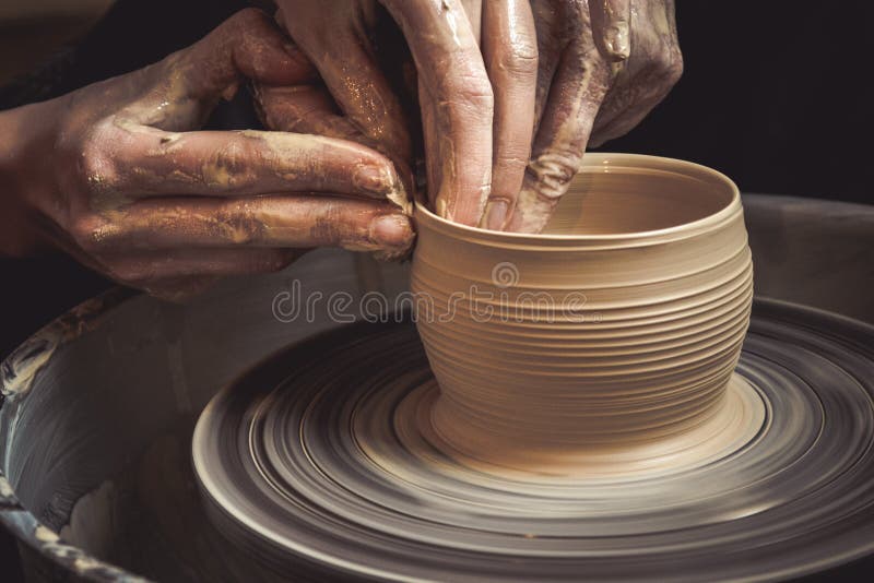 Master class on modeling of clay on a potter`s wheel. In the pottery workshop stock photo