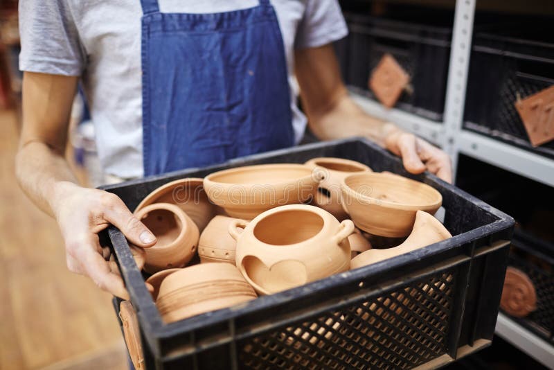 Master of clay pots. Master of pottery carrying box with clay pots stock photography