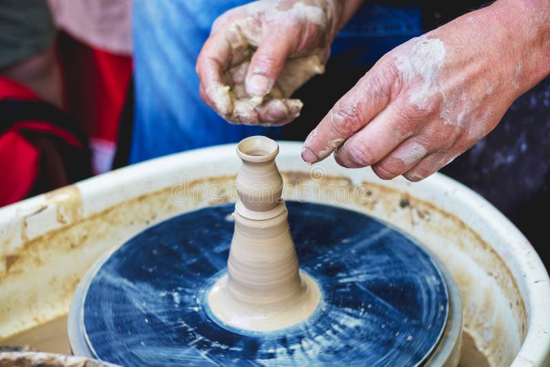 The master produces a miniature jug on a potter`s wheel_. The master produces a miniature jug on a potter`s wheel stock photo