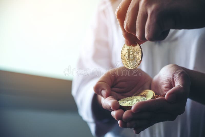 People giving and collecting bitcoins. Closeup image of people giving and collecting bitcoins stock photo