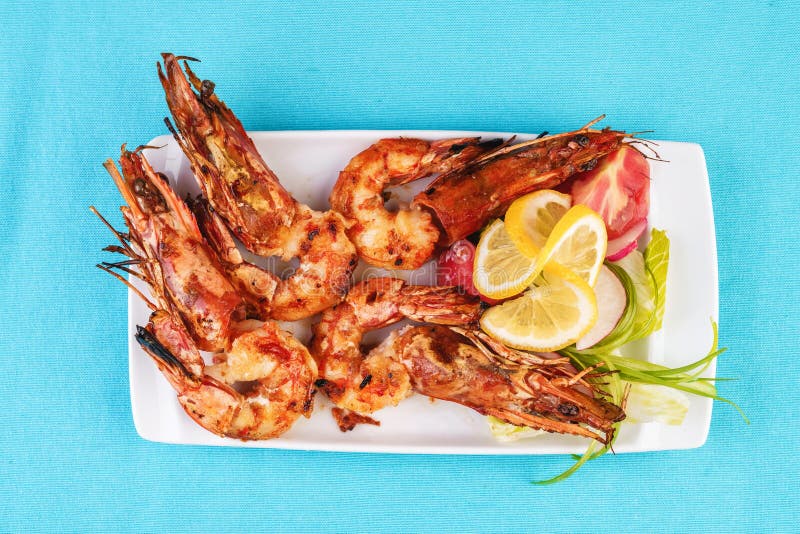 Plate with assorted sea grill for beer. Fried king prawns with lemon, mussels w. European cuisine, Mediterranean dish. Plate with assorted sea grill for beer stock photos