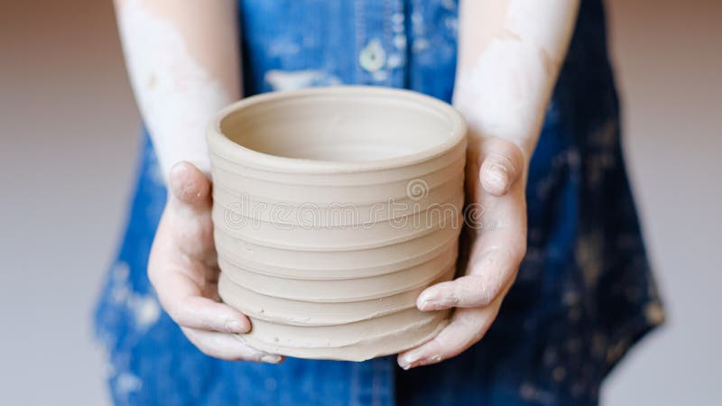 Pottery handcraft hobby hands shape clay wheel. Pottery handcraft hobby. hands showing freshly made crock pot stock photos