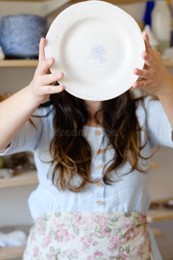 Pottery handcraft hobby handmade clay plate. Pottery handcraft hobby. woman showing a handmade clay plate royalty free stock photos