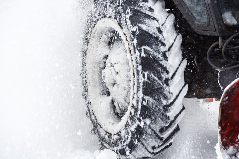 Snow clearing. Tractor clears the way after heavy snowfall. close up of tires. Snowblower grader clears snow covered road. Snow clearing. Tractor clears the way royalty free stock photos