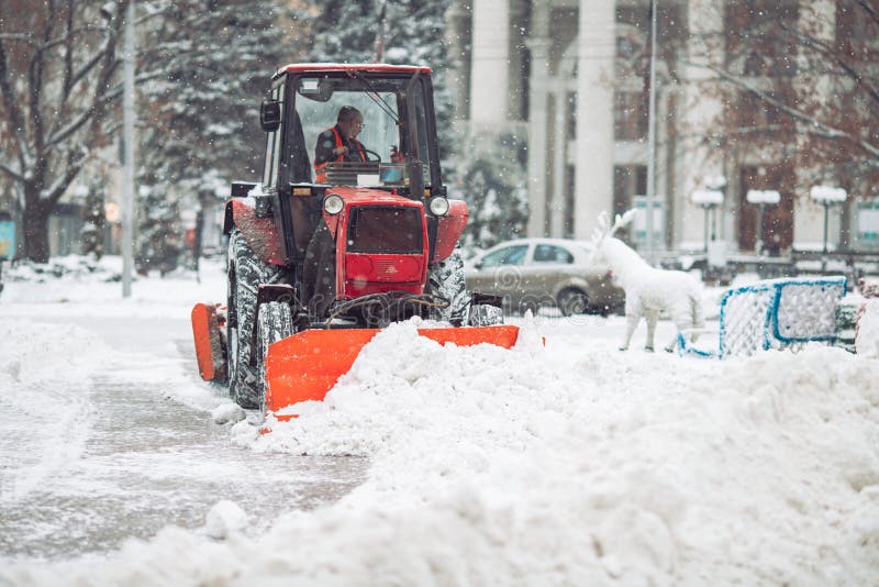 Snow machine cleans the snow in the city. stock photography