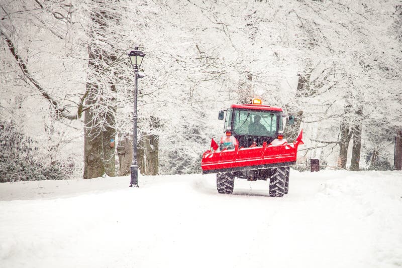tractor cleans road from snow in the winter royalty free stock photo