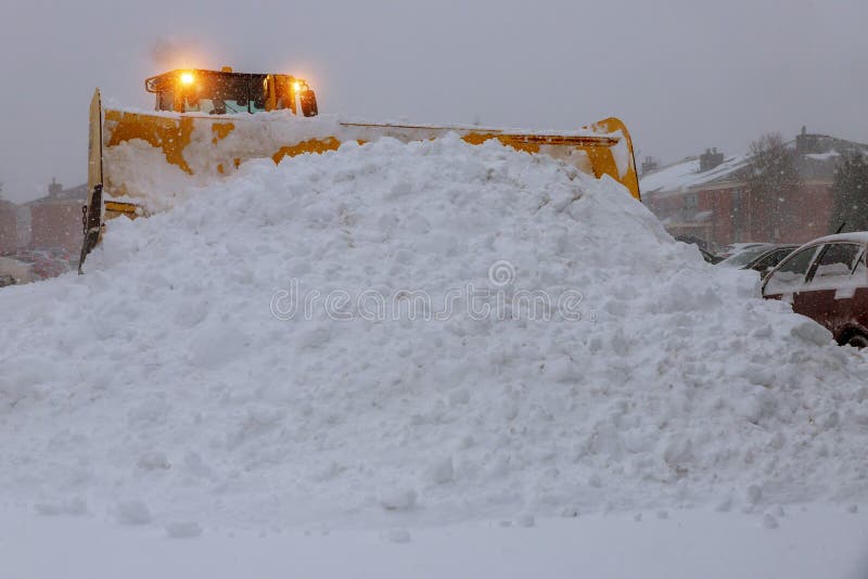 Wheel loader machine tractor removing snow. Clearing the road from ice and snow royalty free stock photos