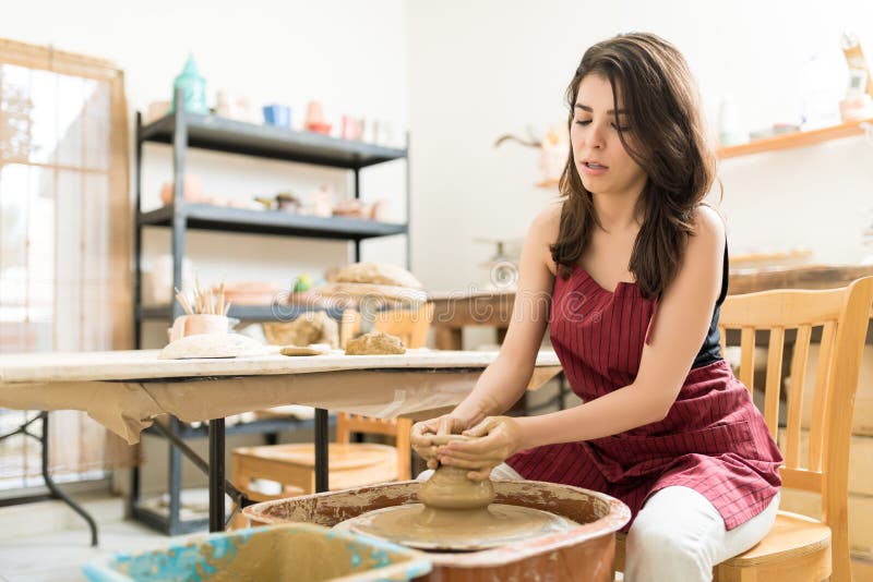 Woman Learning The Art Of Pottery In Studio royalty free stock image