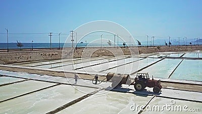 People Work on Salt Fields Pouring Water from Tank stock footage