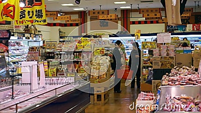 OSAKA, JAPAN - March 2015: People walking and shopping in Supermarket in Japanese local fish market stock footage