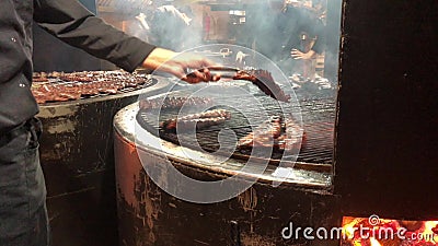 Pork ribs cooked on the fire. Rotating grill for cooking meat. stock video footage